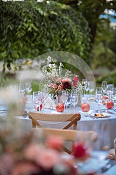 Set table at a wedding reception with floral centerpiece and candles