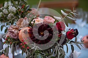 Set table at a wedding reception with floral centerpiece and candles