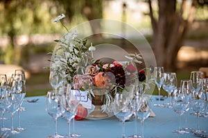 Set table at a wedding reception with floral centerpiece and candles