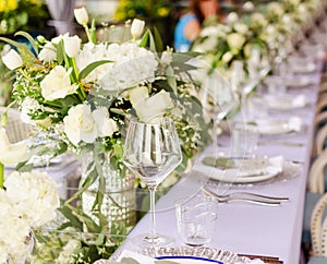 Set table for a white and aqua blue wedding dinner decorated