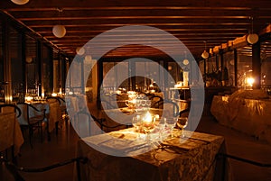 Set tables of a restaurant by candlelight