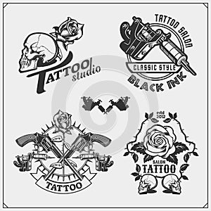 Set of tattoo salon labels, badges and design elements. Tattoo studio emblems with professional equipment.