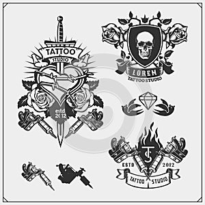 Set of tattoo salon labels, badges and design elements. Tattoo studio emblems with professional equipment.