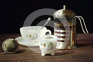 Set of tea on brown wood and black background