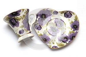 A set of tea cup and saucer with purple flora prints