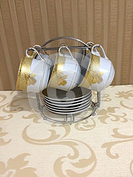 a set of teacups on the table with wallpaper as a background