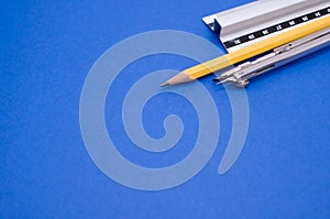 Set of technical drawing tools on a blue background with a copy space
