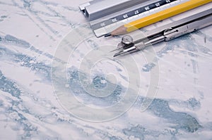 Set of technical drawing tools on a marble background with a copy space