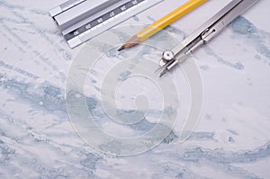 Set of technical drawing tools on a marble background with a copy space