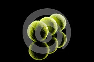set of tennis balls isolated over  the black background