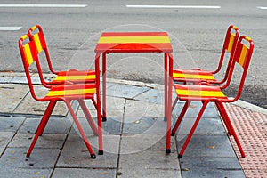 Set of terrace table and chairs, decorated with the flag of Spain.