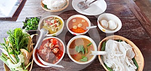 Set of Thai kanomjeen with green curry red curry and fish balls curry.