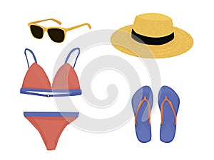 A set of things for the beach: sunglasses, straw hat, swimsuit, flip-flops. outfit for summer holidays.