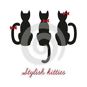 Set of three black cats. Cats that sit back