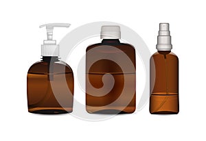 A set of three brown plastic and glass bottles