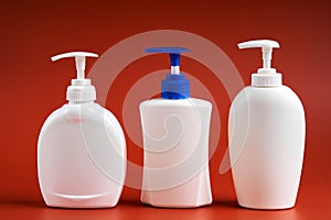 Set of three clean white plastic bottles with soap dispenser