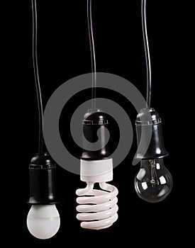 Set of three electric lamps in receptacle on black