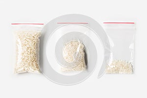 Set of three EMPTY, HALF AND FULL Plastic transparent zipper bag with Uncooked white basmati rice isolated on white. Vacuum packag