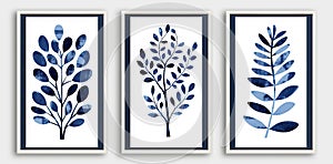 A set of three framed canvases with abstract blue plants on white background.