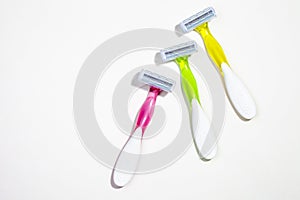 Set of three multi-colored female razors for shaving isolated on white background