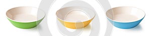 Set of three multicolored ramekins isolated on a white background. Colorful porcelain bowls cutout. Blue, yellow, green dishes.