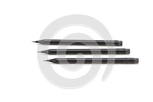 Set of three pencils with rubbers aligned on a white background