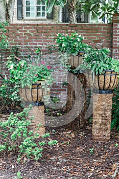 A set of three raised outdoor plants in planter basket liners with a variety of plants for a landscaped unique look