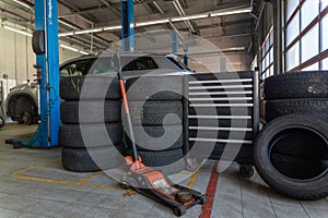 A set of tires for seasonal replacement near the lift in the tire workshop