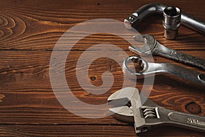 Set of Tools, Adjustable Wrench, Open-End Wrench, Box-end Wrench, Socket Wrench on Wooden Background