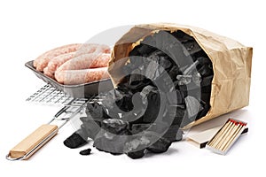 Paper bag of charcoal, grill, sausages. Barbecue preparation set