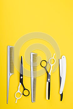Set of tools and items for hair care, and haircuts, on a yellow background