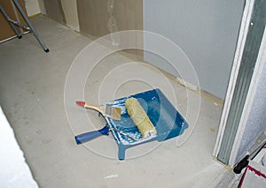 Set of tools for the painter and redecoration on the floor. photo