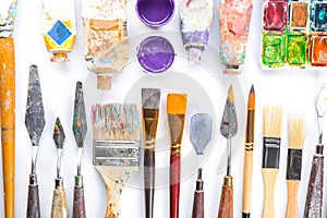 Set of tools with paints on white background