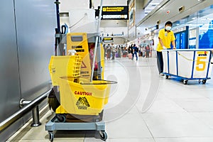 A set of tools and plates for mopping at the airport. Yellow bucket plates and brushes. Cleaning Service