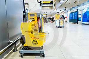 A set of tools and plates for mopping at the airport. Yellow bucket plates and brushes. Cleaning Service