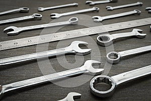 Set of tools for repair wrenches and ruler on a wooden background