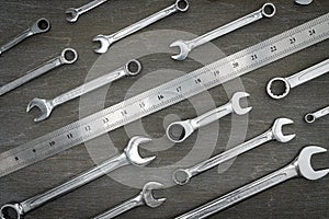 Set of tools for repair wrenches and ruler on a wooden background