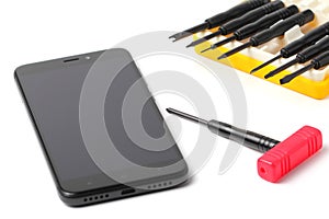 A set of tools for repairing a smartphone or tablet or cell phone. Modern smartphone, copy space. Close-up, copy space, white