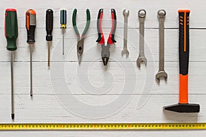 Set of tools for repairs and construstion. Home improvement concept on white wooden background. Copy space