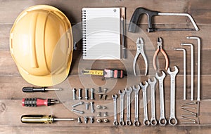 Set tools supplies with blank notebook on wood