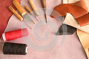 Set of tools with threads on leather in workshop