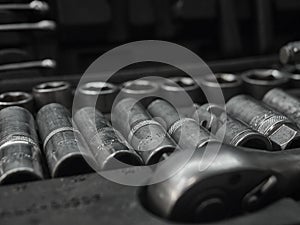 A set of tools and wrenches in a car workshop