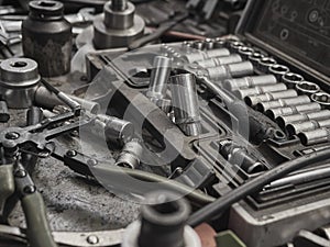 A set of tools and wrenches in a car workshop