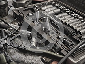 A set of tools and wrenches in a car workshop