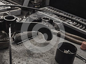 A set of tools and wrenches in a car workshop
