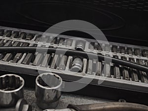 A set of tools and wrenches in a car workshop