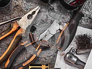 A set of tools and wrenches in a car workshop