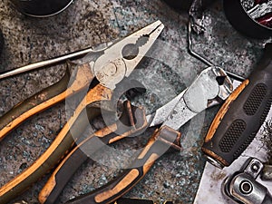 A set of tools and wrenches in a car workshop