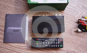 Set-top box for receiving video and TV signal. Remote control. Details and close-up.