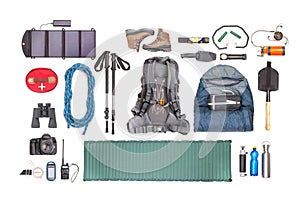 Set of tourist trekking items on white background. Top view of accessories for travel. Equipment for travel and hiking. Survival